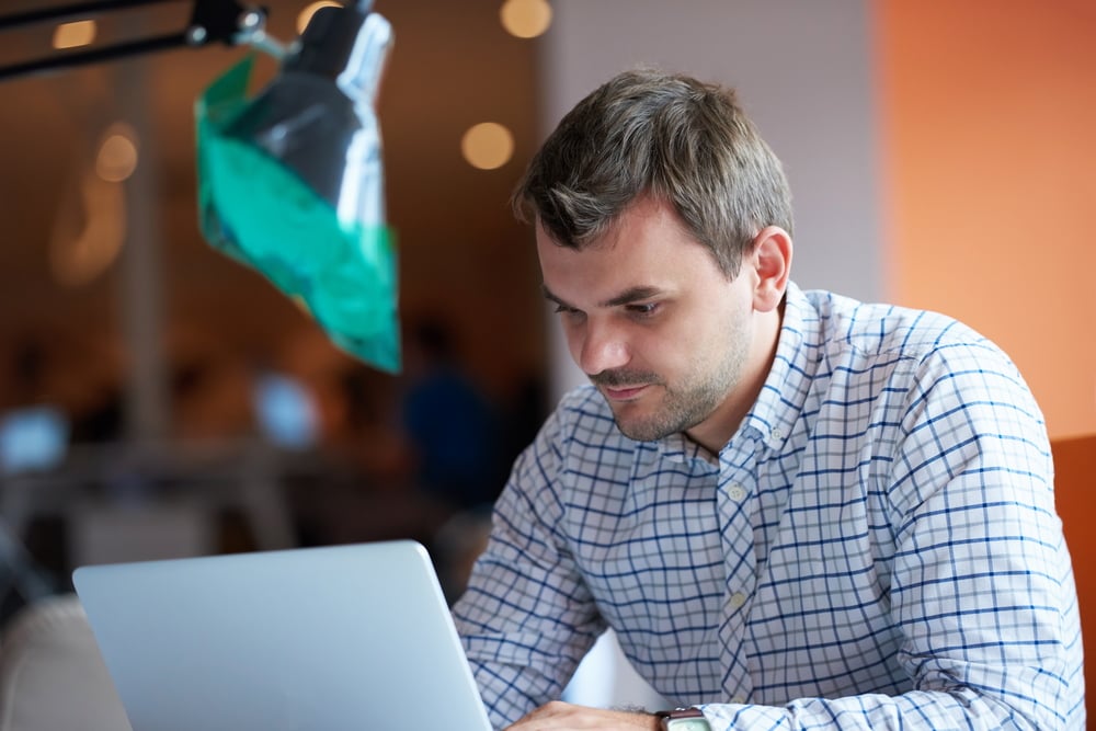 man working with Sage Intacct on laptop