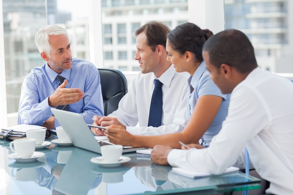 Group of businesspeople brainstorming how to address their B2B ecommerce order fulfillment needs.