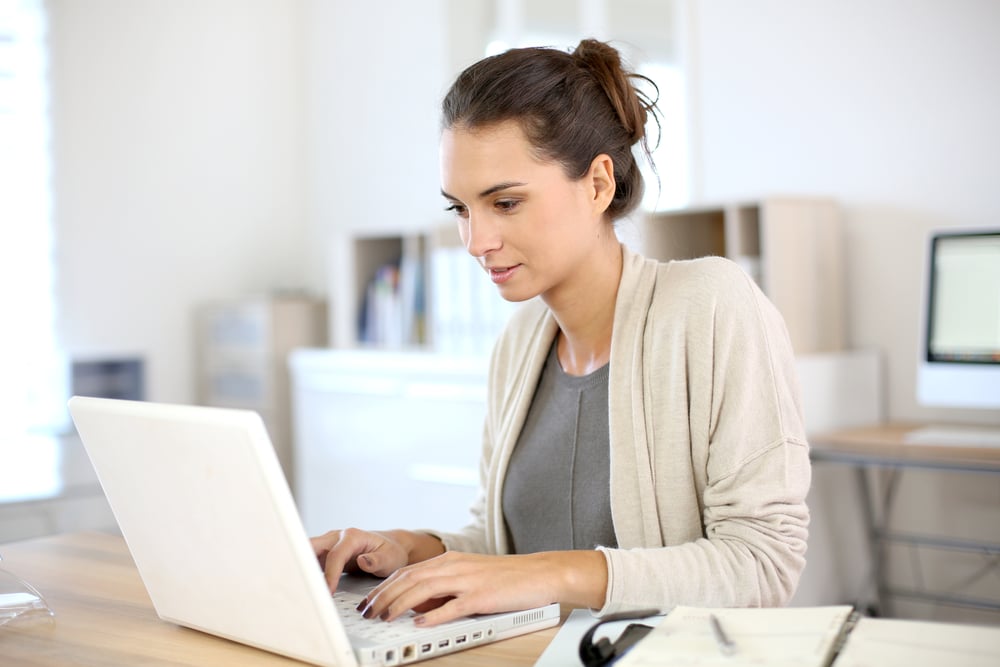 Businesswoman researching which ERP system fits her business.